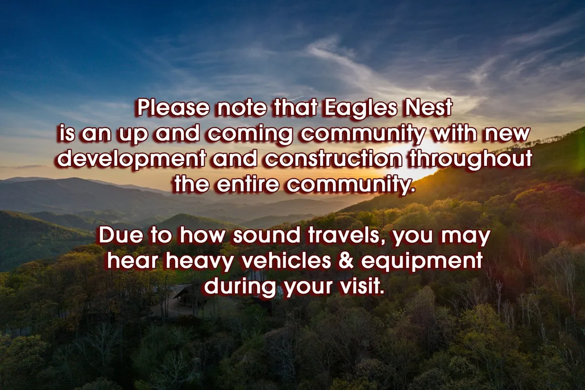 A breathtaking view of a mountain range during sunset, with lush greenery in the foreground. The scene highlights the natural beauty and expansive outdoor adventure opportunities that surround the property.